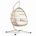 Poltrona sospesa in rattan con struttura in acciaio e cuscini, beige