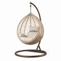 Sedia sospesa in rattan sintetico con struttura in acciaio e cuscini in poliestere, beige